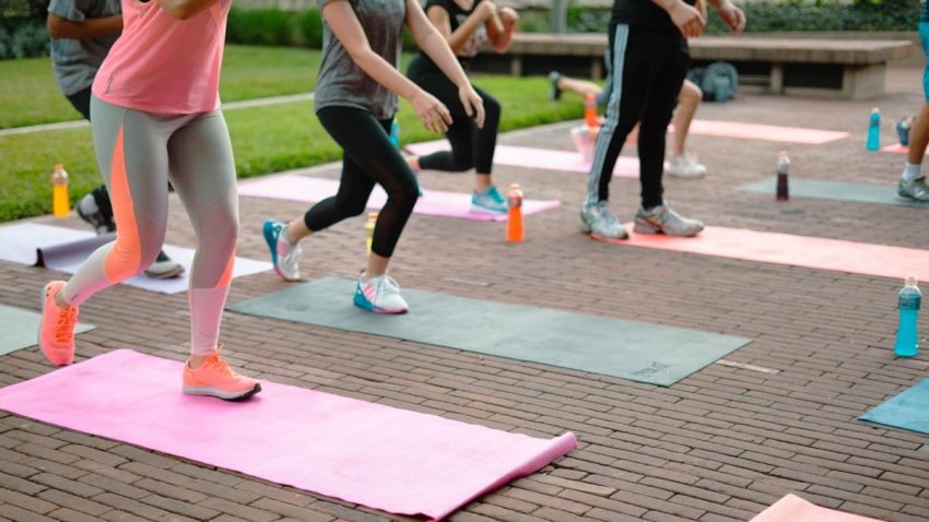 a group of people are doing yoga outside